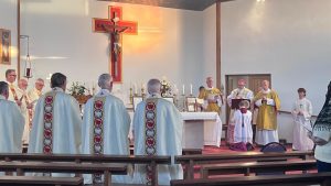 The Bishop, with deacons and concelebrating clergy, at Mass at the Festival